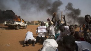 A man holds a sign during a protest against Niger President Issoufou's attendance last week at a Paris rally in support of French satirical weekly Charlie Hebdo, in Niamey
