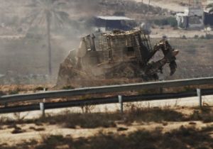 An Israeli military bulldozer is seen in the northern Gaza Strip, near the border with Israel