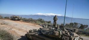 an-israeli-soldier-stands-atop-a-tank-near-border-with-lebanon_5196293