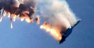 An image grab made from a video shows a burning Russian fighter jet coming down after being shot down near the Turkish-Syrian border, in Hatay on November 24, 2015. NATO member Turkey shot down a Russian fighter jet on the Syrian border today, threatening a major spike in tensions between two key protagonists in the four-year Syria civil war. AFP PHOTO / IHLAS NEWS AGENCY ***TURKEY OUT*** / AFP / IHLAS NEWS AGENCY / -