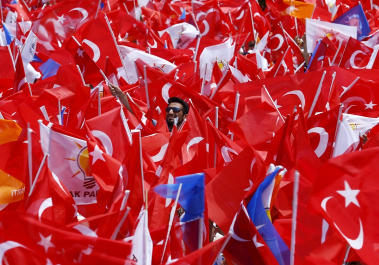 Supporters of the ruling AK Party wave Turkish national and party flags as they listen to Turkish Prime Minister Ahmet Davutoglu (not pictured) during an election rally for Turkey's June 7 parliamentary election, in Antalya, Turkey, June 6, 2015. REUTERS/Umit Bektas       TPX IMAGES OF THE DAY      - RTX1FDRF