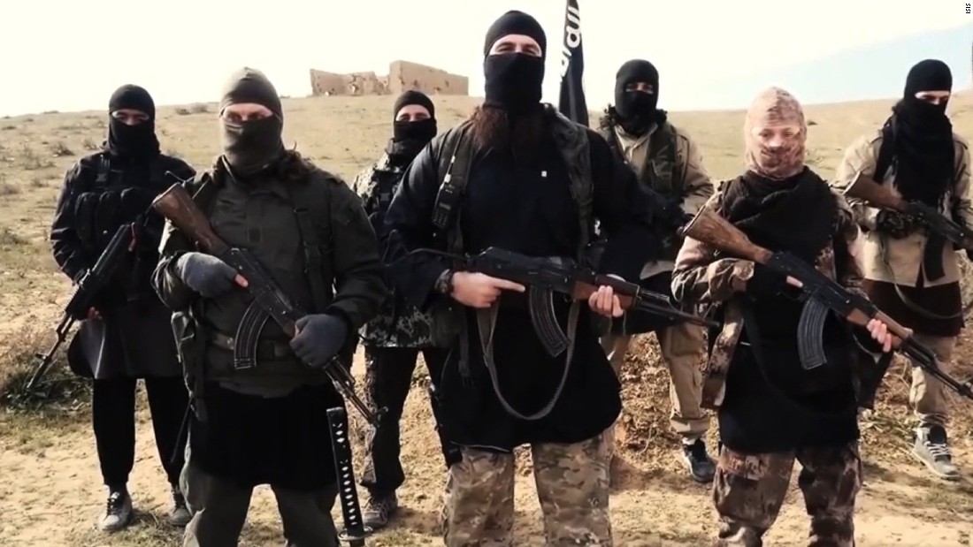 aStill photo from the latest video released by French-speaking ISIS fighters. French authorities say a woman in the video released may be Hayat Boumeddiene, who is believed to have knowledge about the deadly January 9 attack on a Paris kosher grocery, a source close to the investigation told CNN. The woman is shown in the video in the front row with a group of fighters on the left in the tan head covering.